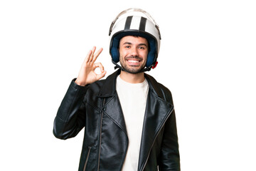 Young caucasian man with a motorcycle helmet over isolated chroma key background showing ok sign...