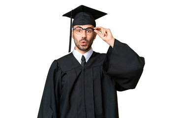 Young university graduate man over isolated chroma key background with glasses and surprised