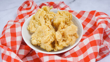 Homemade Crispy Popcorn Chicken bites over marble background. Top view.