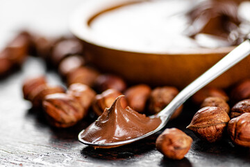 Hazelnut butter in a spoon on the table. 