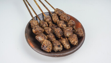 Grilled meatballs (bakso bakar), isolated on white background. Traditional food from East Java, Indonesia.