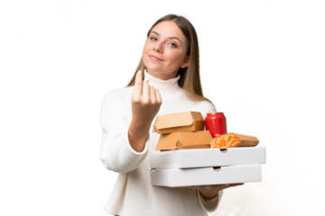 Young beautiful blonde woman holding takeaway food over isolated background doing coming gesture