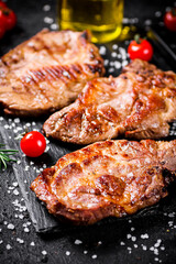 Grilled pork steak with cherry tomatoes and rosemary. 