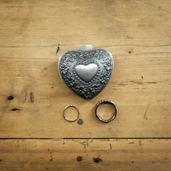 wedding rings on table heath shaped box