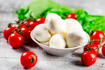 Mozzarella cheese with cherry tomatoes and herbs.