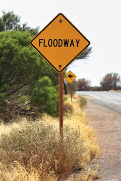 W-5-7-1 road sign: black FLOODWAY word on yellow background warning symbol. Petermann-Australia-426