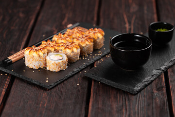 Sushi roll philadelphia with crab avocado and cream cheese on black background close-up. Sushi menu. Japanese food concept