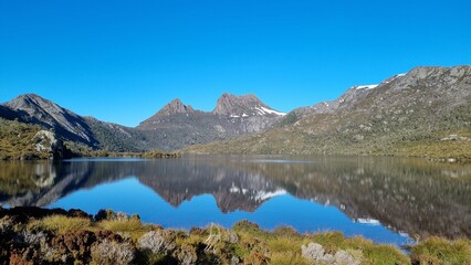 Fototapeta na wymiar Reflection of the Cradle Mountain peaks in the lake.