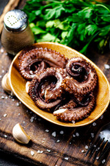 An octopus on a wooden plate. 