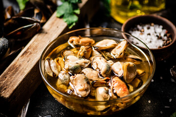 Pickled mussels with parsley and spices on the table. 