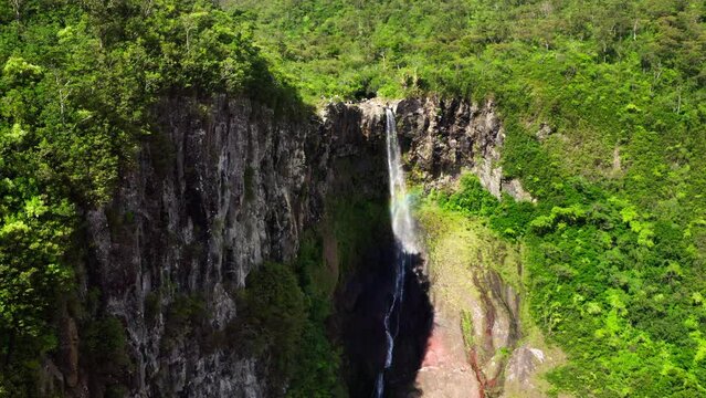 Picturesque flying over the mountain creek fall down from steep high cliff to wide green jungle valley. Cascade 500 Pieds waterfall also known as Cascade des Galets on Mauricius island in Indian ocean