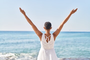 Fototapeta na wymiar African american woman standing on back view at seaside