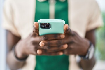 African american man using smartphone at home