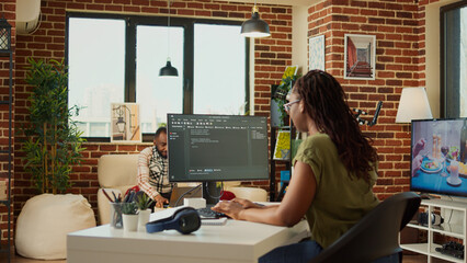 Female developer working on IT software program to create web database with html script and code. Programming artificial intelligence on terminal window, doing remote job from home.