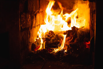 Fototapeta premium Stove oven with a flame inside. Fire in a fireplace for heating the house the firewood. Winter harmony meditation