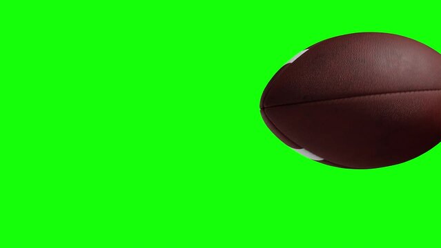 American football ball. Thrown and slowly flying past the camera. File made with alfa channel. 