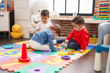 Group of kids playing xylophone sitting on floor at kindergarten
