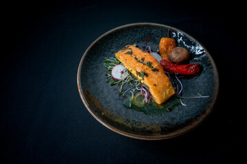 cookced  Salmon Fillet with Roasted Vegetables on a Plate