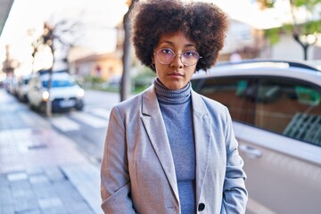 African american woman executive standing with relaxed expression at street