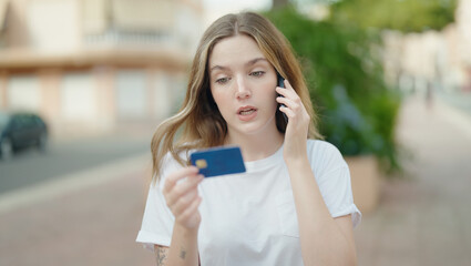 Young caucasian woman using smartphone and credit card at park
