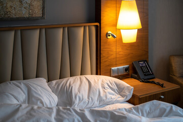 Hotel room with a comfortable bed, clock and modern decor