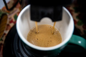 delicious, aromatic coffee flowing from the machine