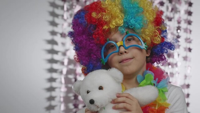 Boy of 10 years old dressed in clown's wig and eyeglasses. 