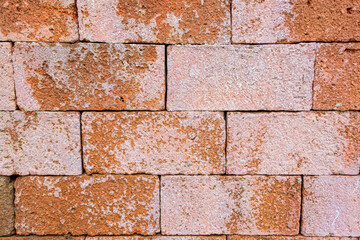 Rust and cream color concrete brick wall background and wallpaper texture