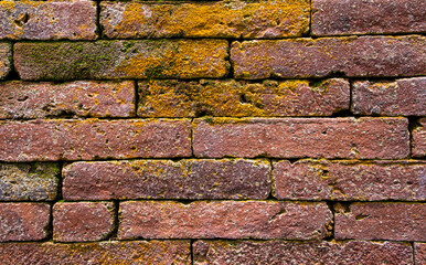 Old red brick wall with uneven pattern background and wallpaper texture