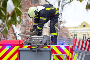 firefighter man works on his fire truck. fire safety service