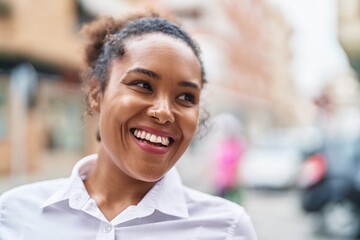 African american woman smiling confident looking to the side at street