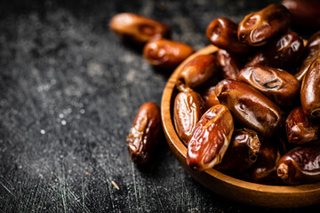 Ripe dates on a plate on the table. 
