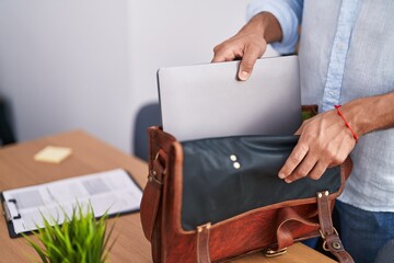 Young arab man business worker holding laptop at office