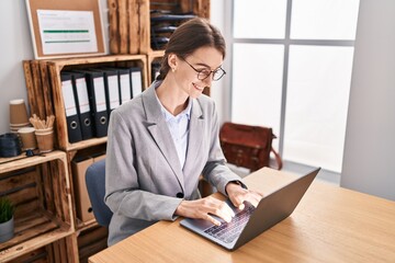 Young caucasian woman business worker using laptop working at office