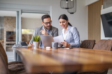 Two coworkers at the office discuss about business strategy of new investments