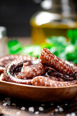 An octopus on a wooden plate. 