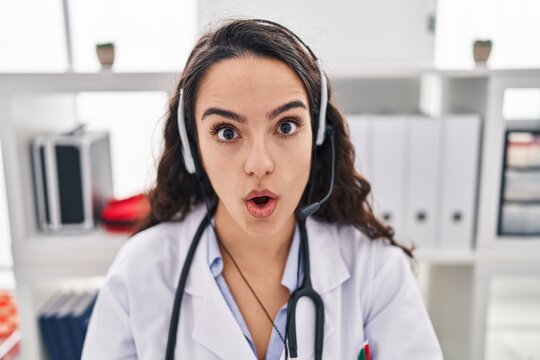 Young Doctor Woman Working On Online Appointment Scared And Amazed With Open Mouth For Surprise, Disbelief Face