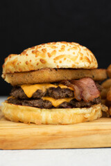 Burger cheese with potato in wooden table and black backgournd 