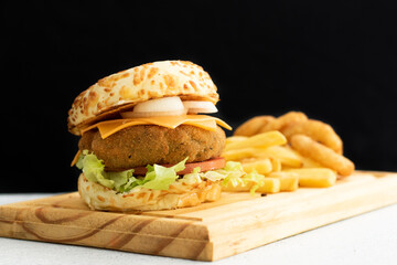 Burger cheese with potato in wooden table and black backgournd 