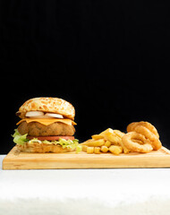 Burger cheese with potato in wooden table and black backgournd 