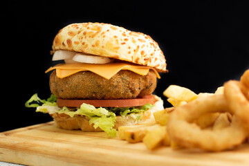 Burger cheese with potato in wooden table and black backgournd 