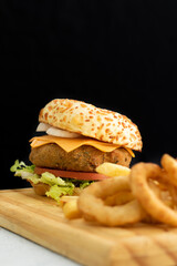 Burger cheese with potato in wooden table and black backgournd 