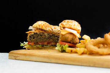 Burger cheese with potato in wooden table and black backgournd 