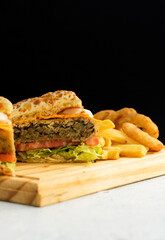 Burger cheese with potato in wooden table and black backgournd 