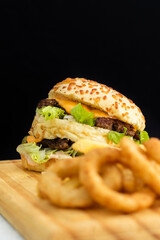 Burger cheese with potato in wooden table and black backgournd 