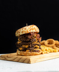Burger cheese with potato in wooden table and black backgournd 