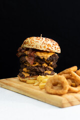 Burger cheese with potato in wooden table and black backgournd 