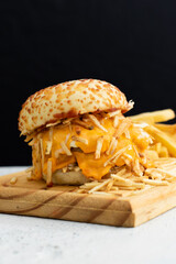 Burger cheese with potato in wooden table and black backgournd 