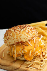 Burger cheese with potato in wooden table and black backgournd 