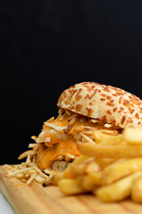 Burger cheese with potato in wooden table and black backgournd 